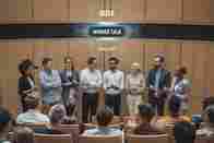 a-photo-of-a-modern-auditorium-with-a-small-group--as1mONIWQlKqxOoFNf_6gA-gbNQRuv8QDy2wYWv81GneA.jpeg